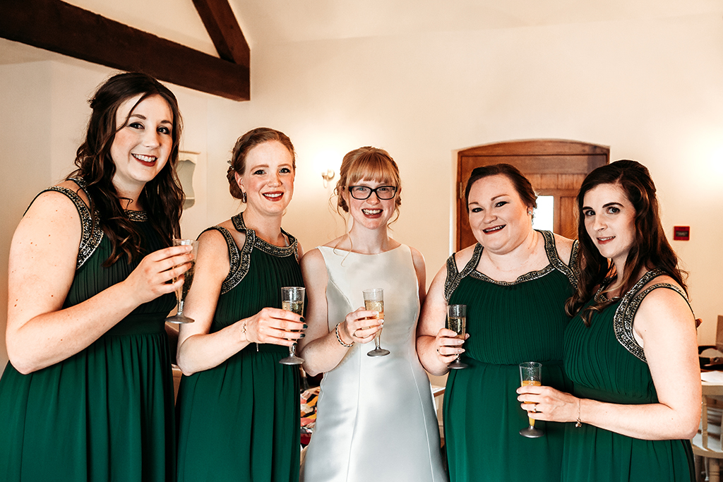 The bridesmaids wore forest green dresses at this spring wedding at Sandhole Oak Barn 