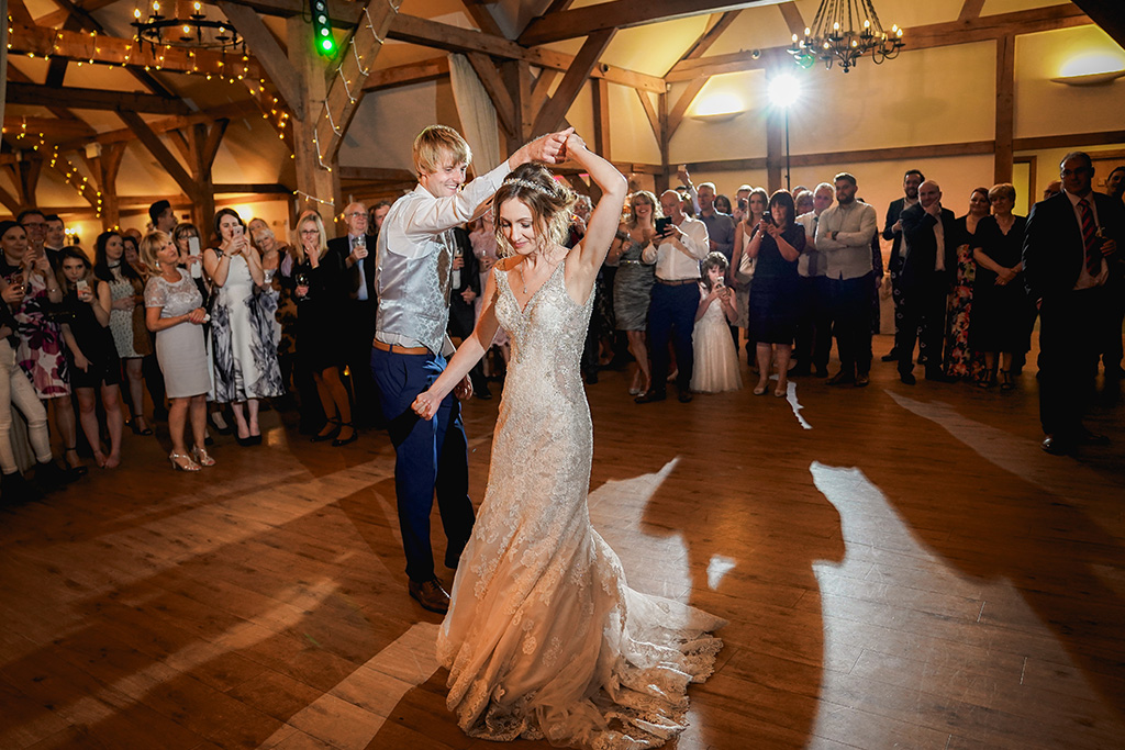 The bride and groom take to the floor for their first dance at this Cheshire barn venue 