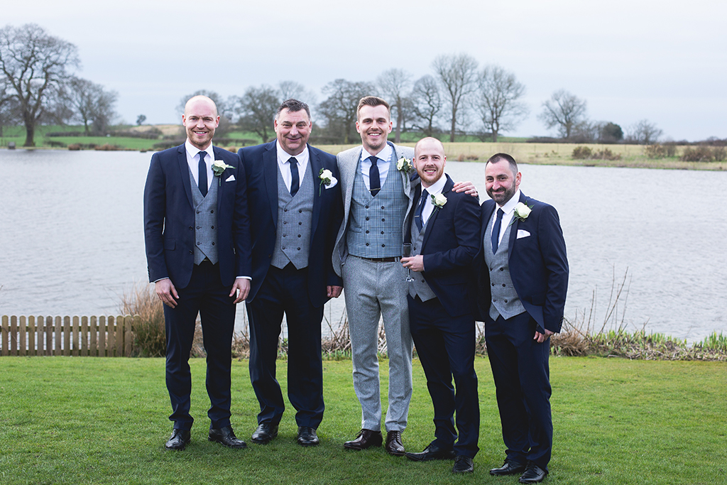 The groom wore a grey three piece suit and the groomsmen had matching waistcoats with navy suits at this rustic barn wedding in Cheshire