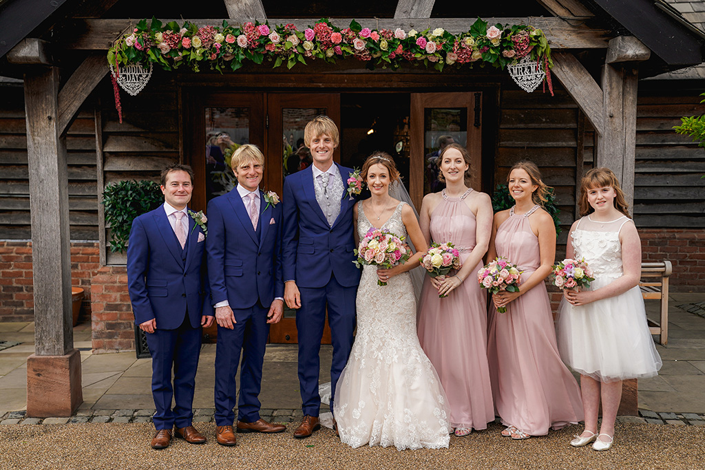The bridesmaids wore pretty blush pink dresses and the groomsmen wore navy suits with matching pink ties 