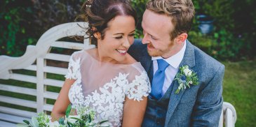 The happy couple enjoy a moment in the gardens at their barn wedding in Cheshire