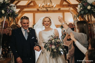 The happy couple prepare to celebrate with their wedding guests at their wedding reception at Sandhole Oak Barn near Manchester
