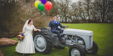 The bride and groom have their wedding photos taken in the surrounding fields at this countryside wedding venue in Cheshire