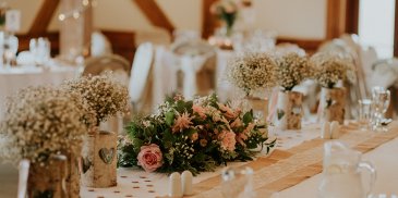 Beautiful spring wedding flowers adorned the top table at this rustic wedding at Sandhole Oak Barn