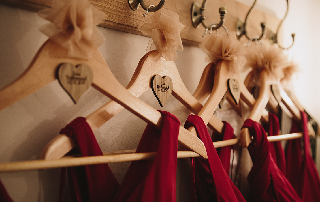 Red bridesmaid dresses are a perfect choice for a valentine wedding at Sandhole Oak Barn