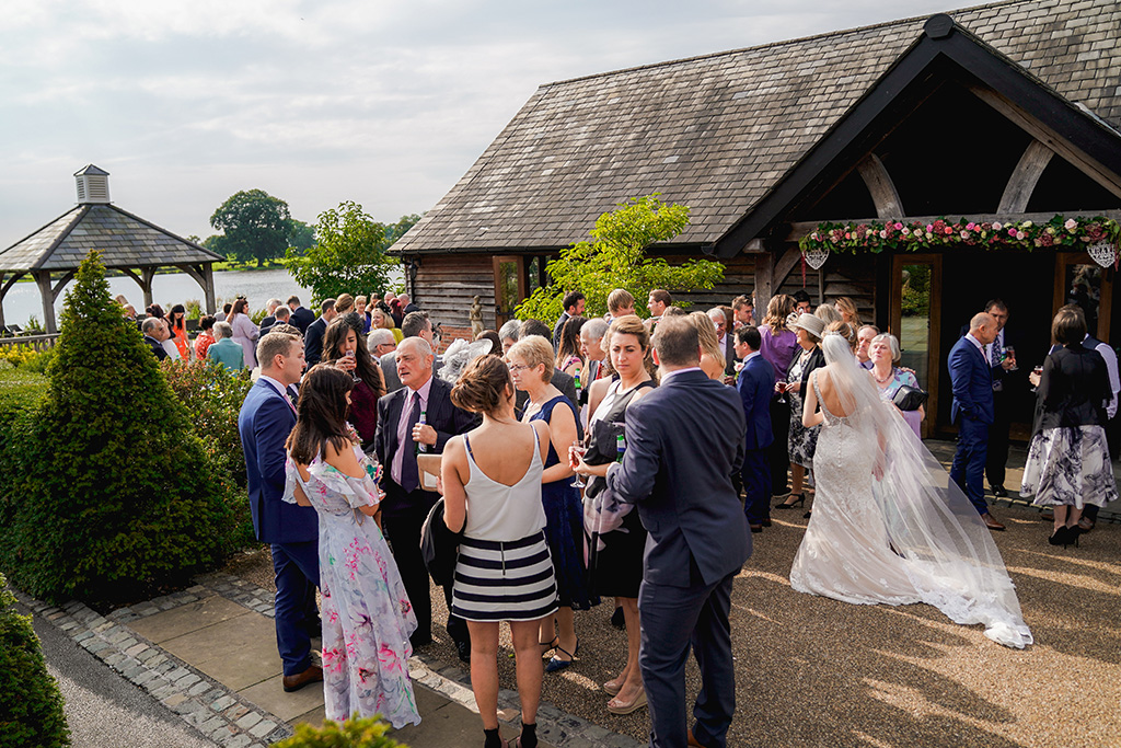 The guests mingle after the wedding ceremony at Sandhole Oak Barn Cheshire 